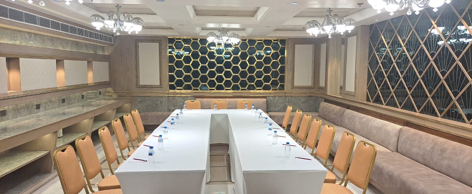 An event space with chairs arranged on both sides and tables placed in the middle at BluSalzz Residence, Amritsar